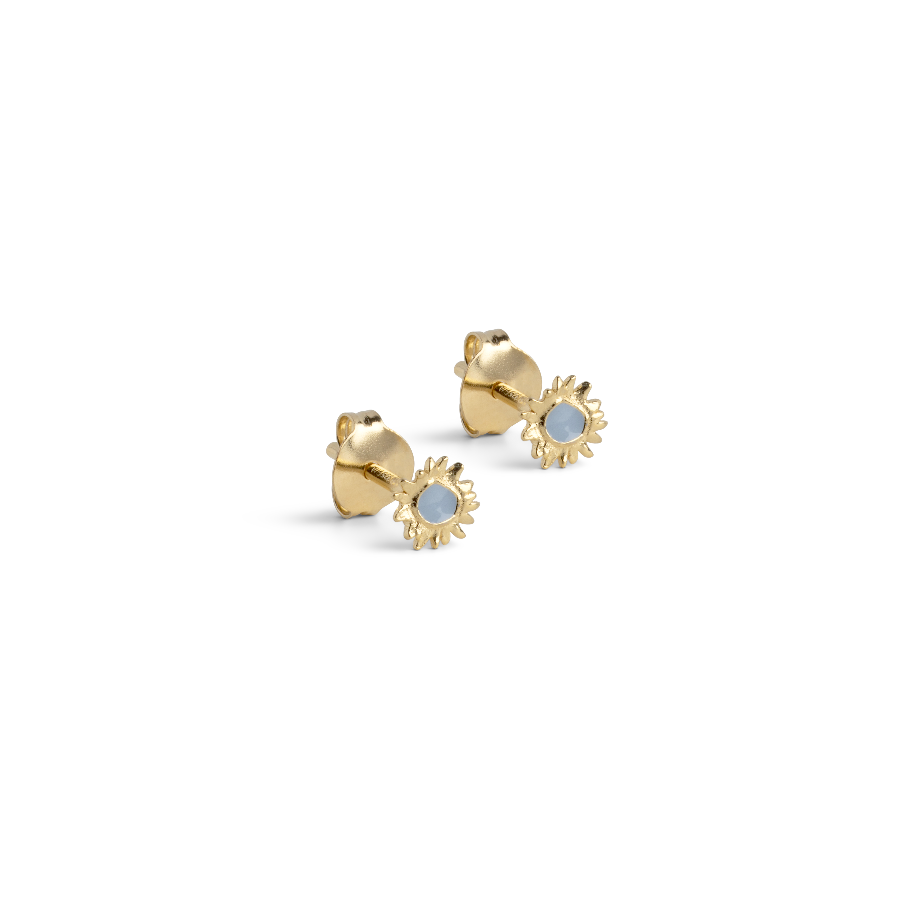 Enamel Mini Sunshine Stud Steel Blue zeigt einen Satz kleiner goldfarbener Ohrstecker mit blauer Emaille. Modell e419g-steelblue-1.
