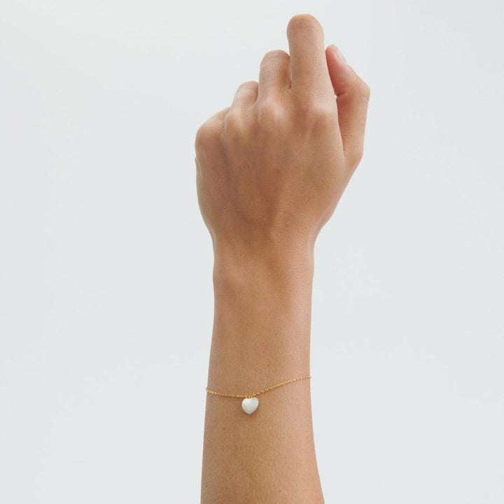 Pernille Corydon Ocean Heart vergoldetes Armband am Handgelenk mit weißem Herzanhänger, Modell B-387-GP