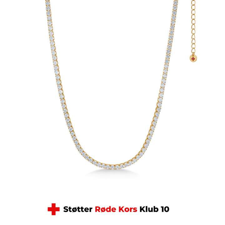 studio-z-tennis-necklace-in-gold-lated-sol-30-36cm-7227000, elegante Tenniskette aus vergoldetem Silber mit klaren Steinen auf grünem Hintergrund. Modell 7227000