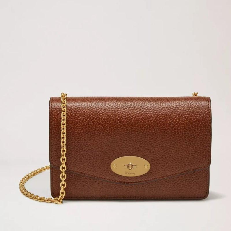 Mulberry Tasche Darley Oak Small Classic Grain Leather zeigt eine braune Ledertasche mit einem goldenen Kettenriemen. Modell RL7413552G110